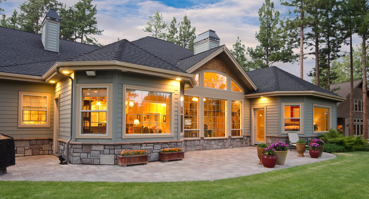 Rear dusk patio with seating and landscape lighting